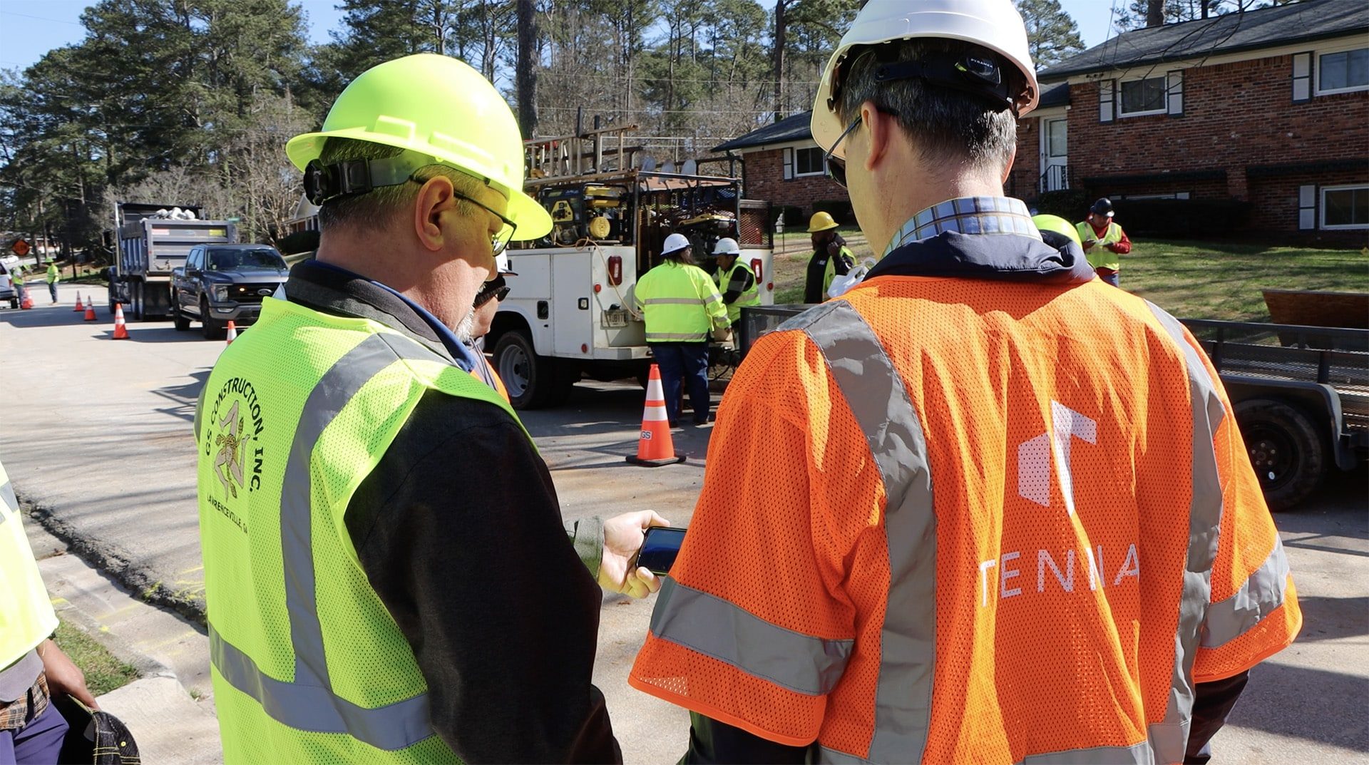 Tenna employee working with a GS Construction employee in the field